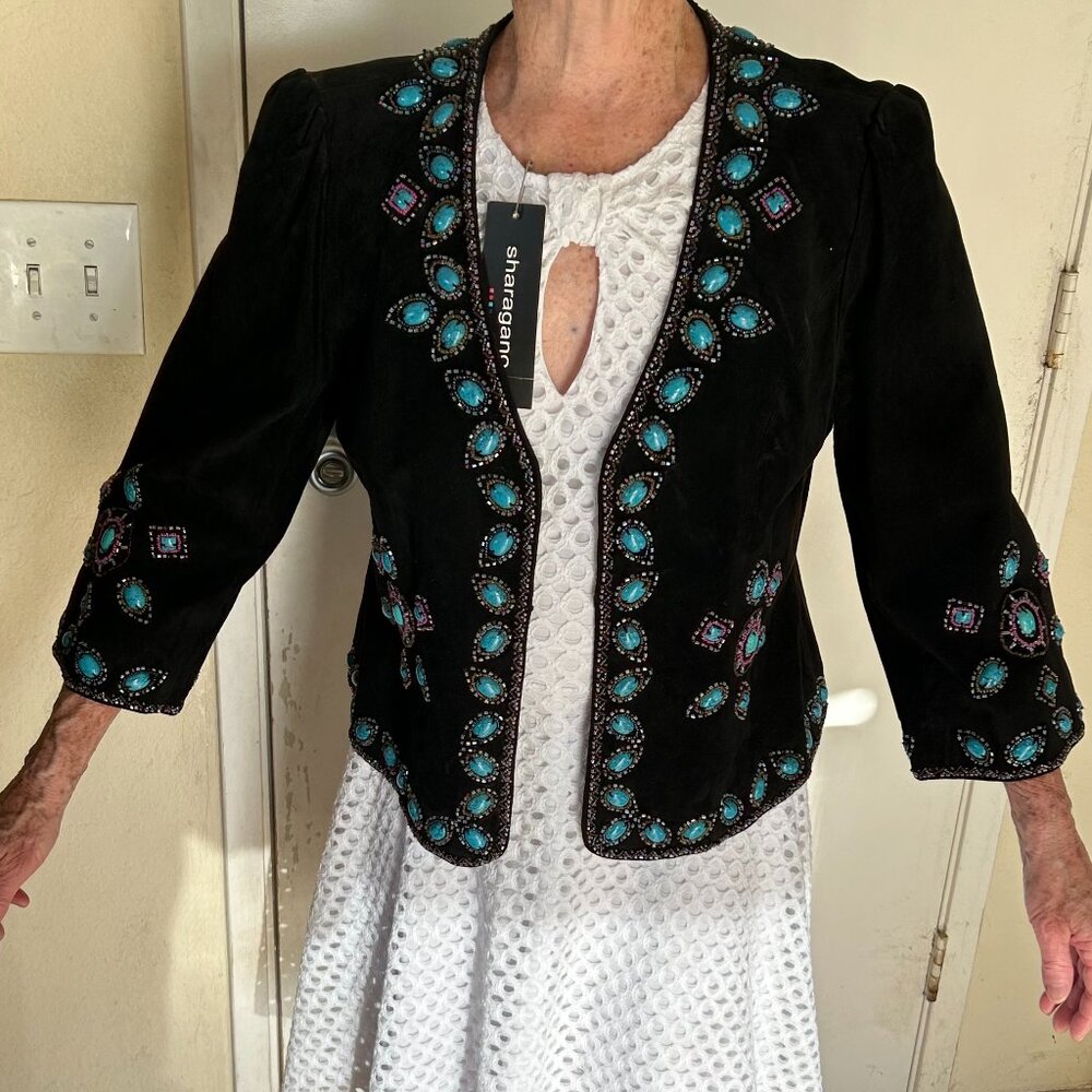 Leather  jacket with turqouise accents.